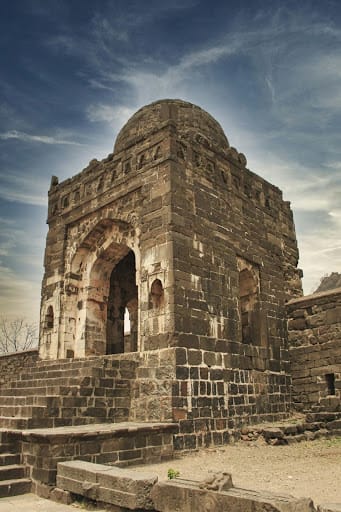 Ancient stone structure at Daulatabad Fort, Maharashtra, featuring Indo-Islamic architecture with arched entrance and domed roof